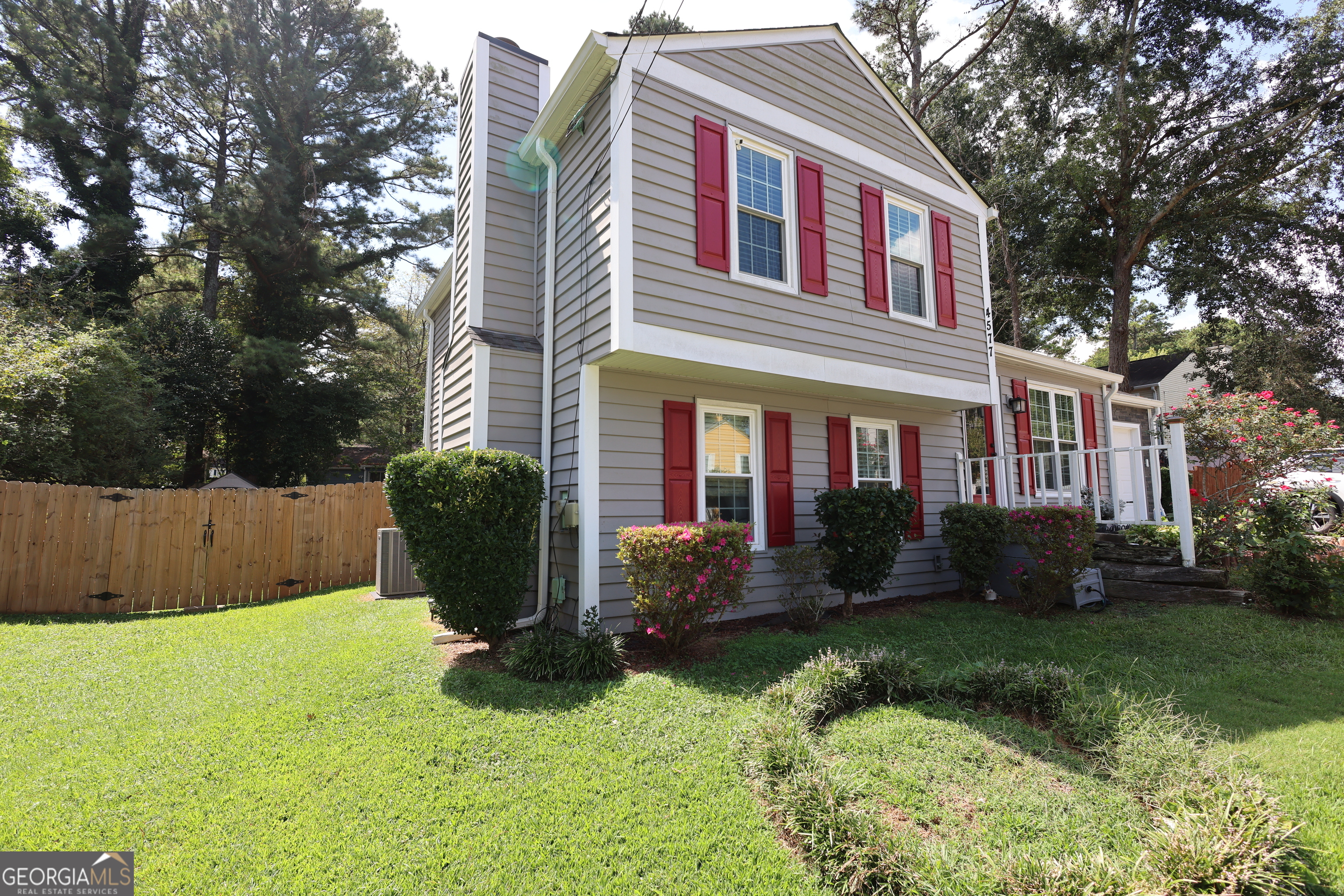 4577 Arborwalk Court Stone Mountain, GA 30083 - Photo 2 of 19 a front view of a house with a yard and plants