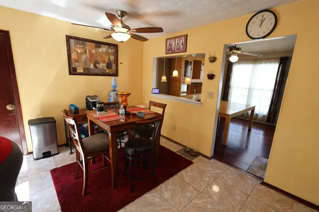 a view of a dining room with furniture and chandelier