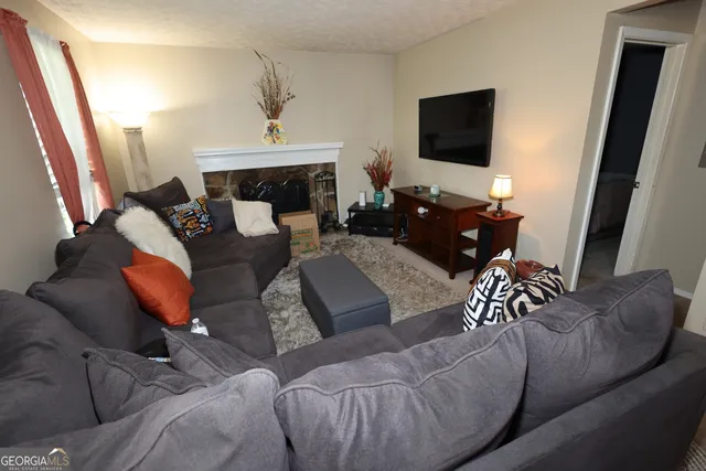a living room with furniture and a flat screen tv