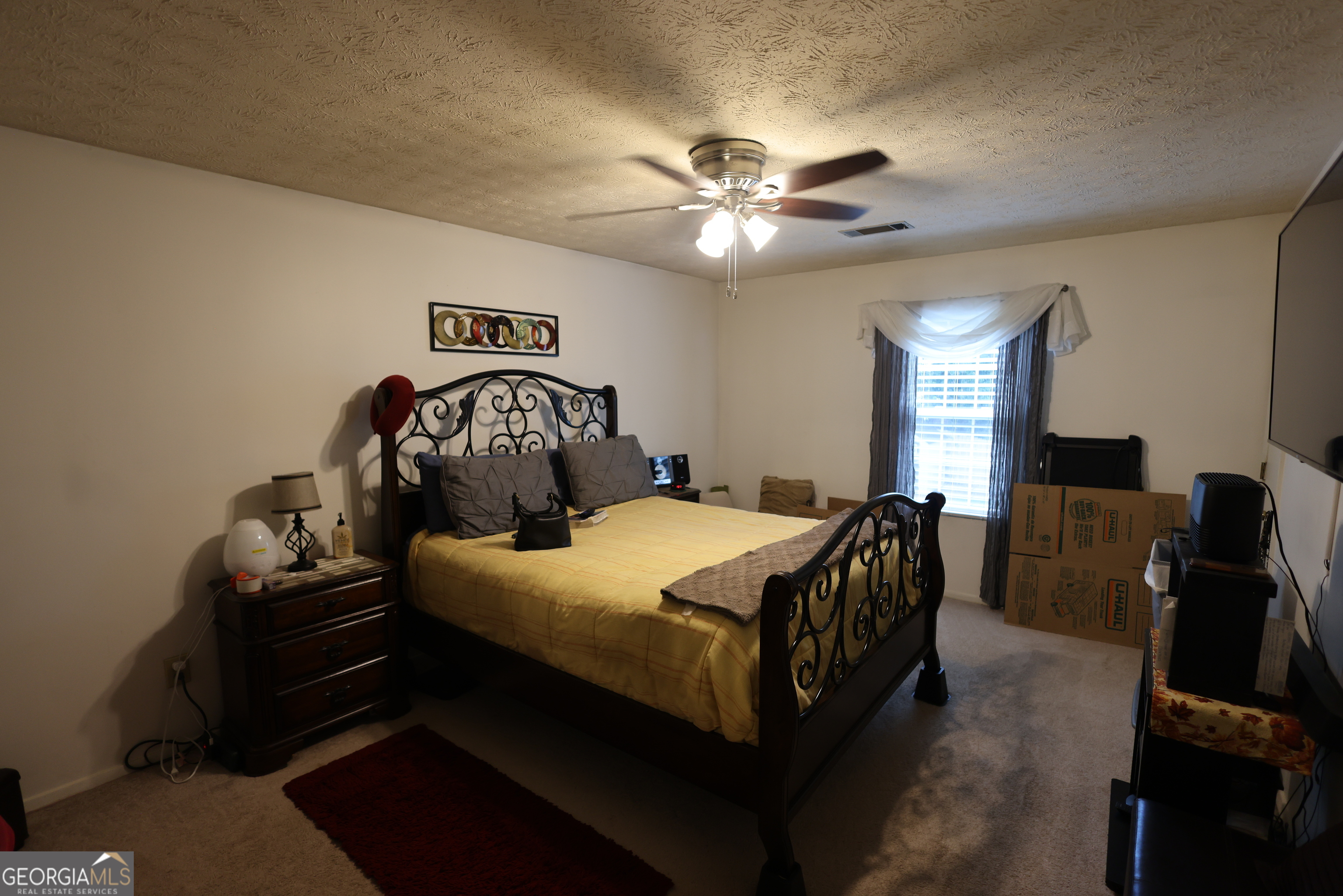 4577 Arborwalk Court Stone Mountain, GA 30083 - Photo 9 of 19 a bedroom with a bed and wooden floor
