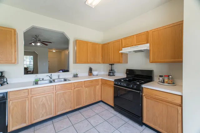 a kitchen with a sink stove top oven and cabinets