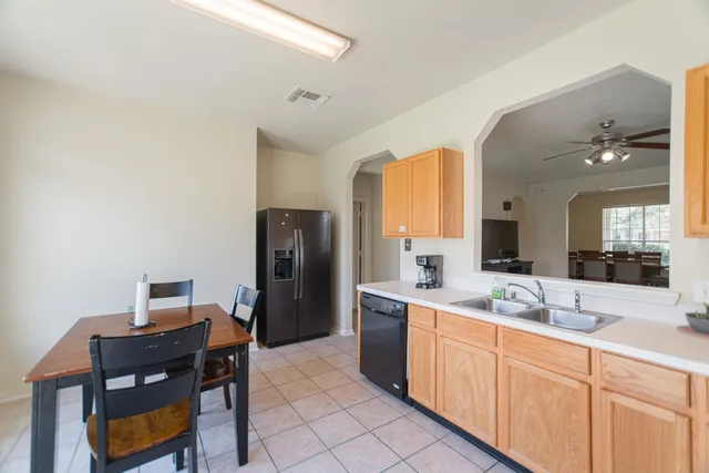 a kitchen with a table chairs and refrigerator