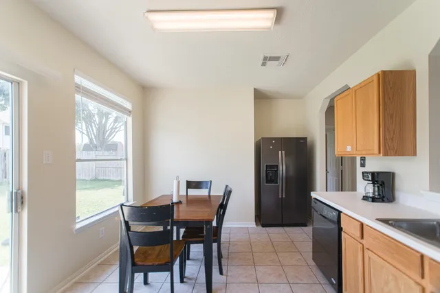 a kitchen with white cabinets and appliances