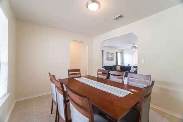 a dining room with furniture and window
