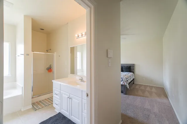 a bathroom with a tub sink and mirror