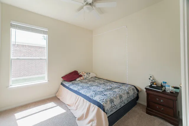 a bedroom with a bed and a window