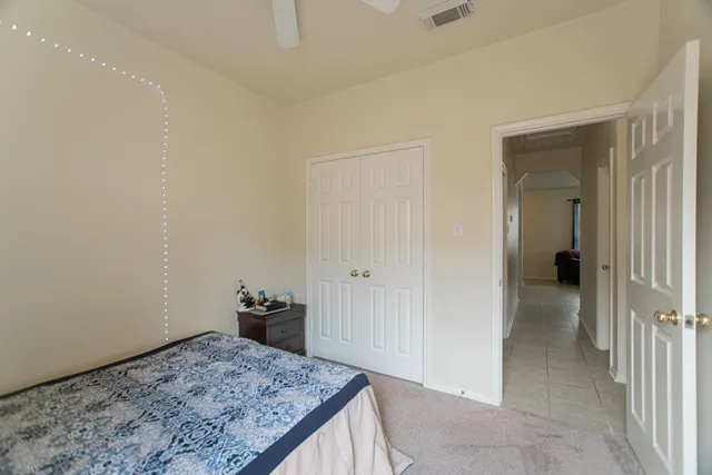 a bedroom with a bed and a white cabinet