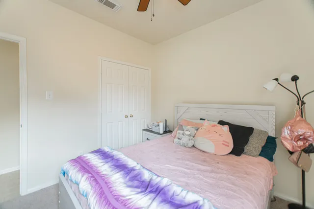 a front view of a house with a garden and yard