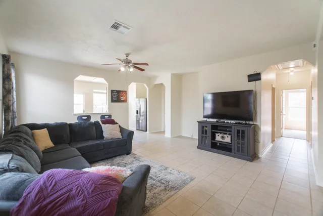 a living room with furniture and a flat screen tv
