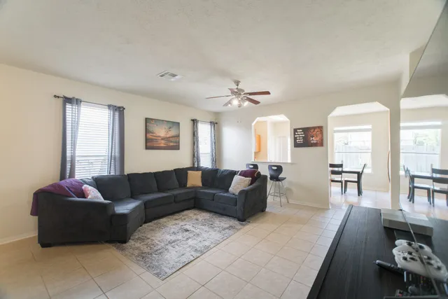a living room with furniture and wooden floor