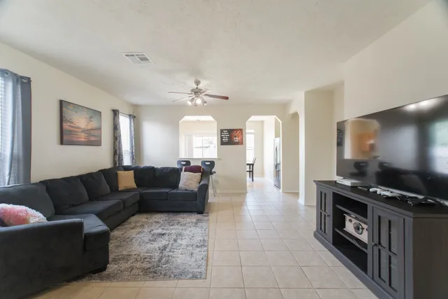 a living room with furniture and a flat screen tv
