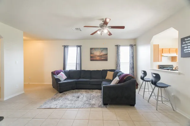a living room with furniture and a large window