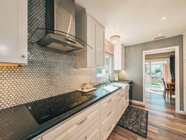 a kitchen with a sink and a stove top oven