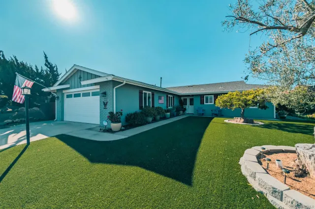 a view of a house with a yard porch and sitting area