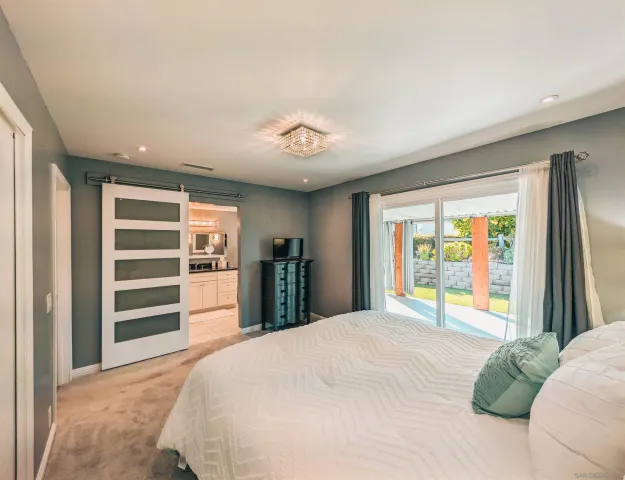 a bedroom with a large bed and a window