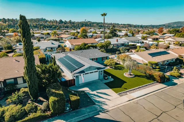 an aerial view of residential houses with outdoor space