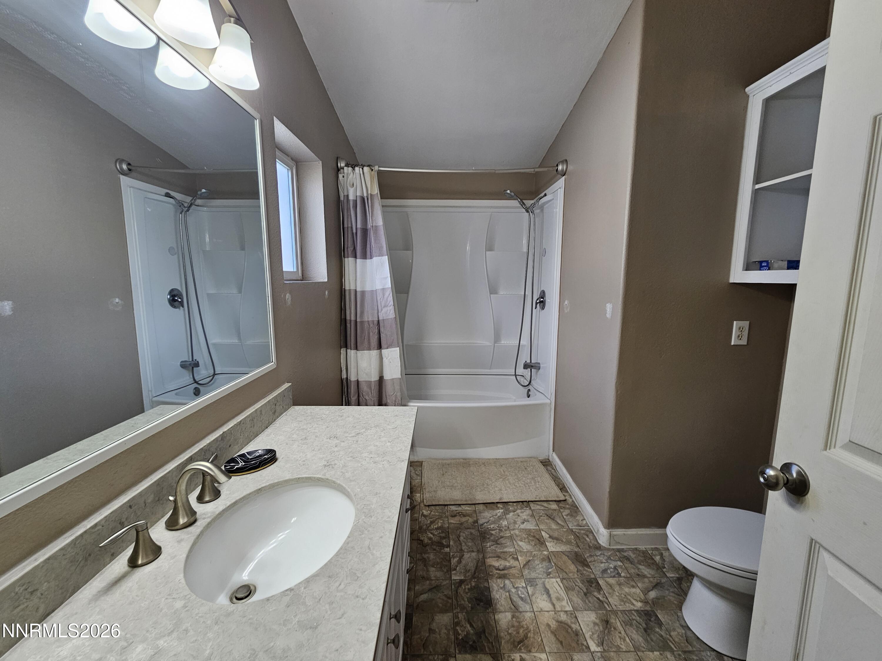 1125 Rancho Road Fernley, NV 89408 - Photo 18 of 47 a bathroom with a sink a toilet a mirror and shower