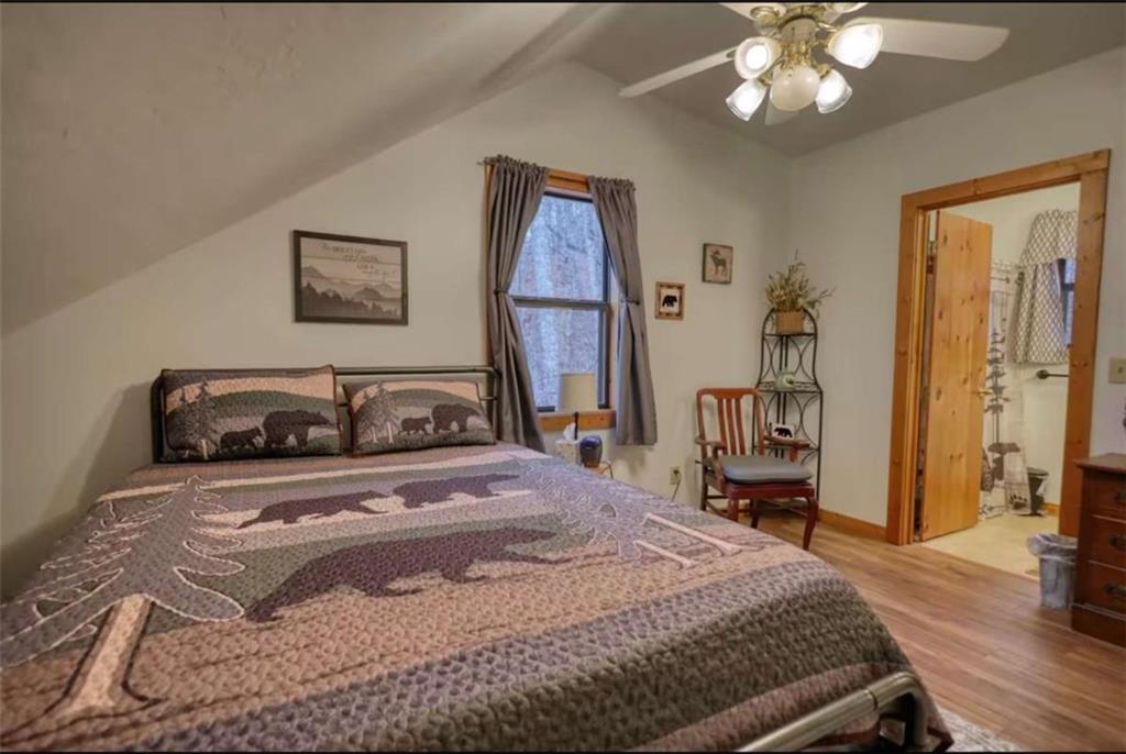 2531 Hunter Road Hiawassee, GA 30546 - Photo 22 of 30 a bedroom with a bed and a chandelier