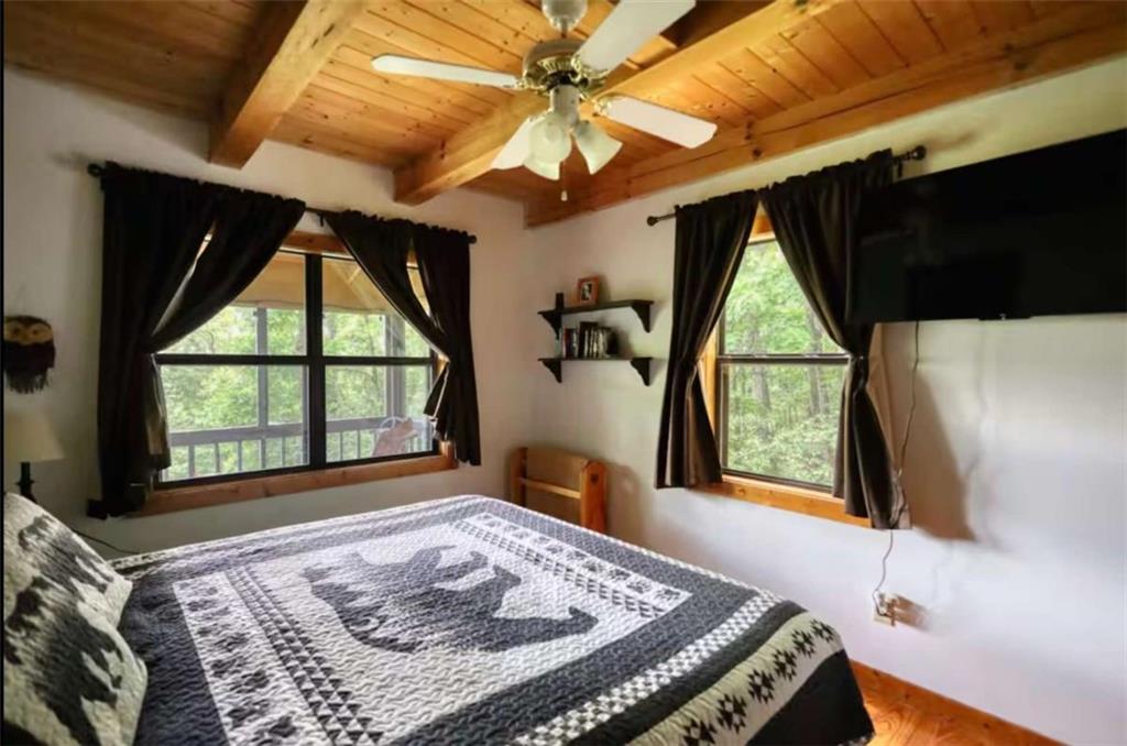 2531 Hunter Road Hiawassee, GA 30546 - Photo 23 of 30 a bed sitting in a bedroom next to a window