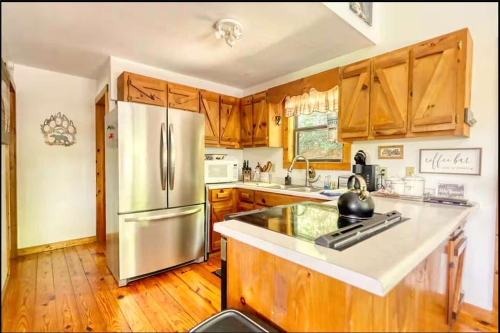 2531 Hunter Road Hiawassee, GA 30546 - Photo 27 of 30 a kitchen with a refrigerator a sink and cabinets
