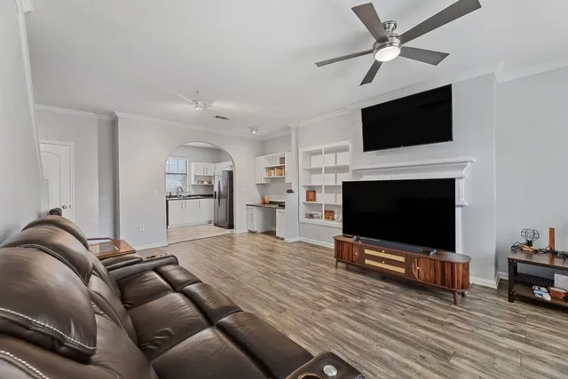 a living room with furniture and a flat screen tv
