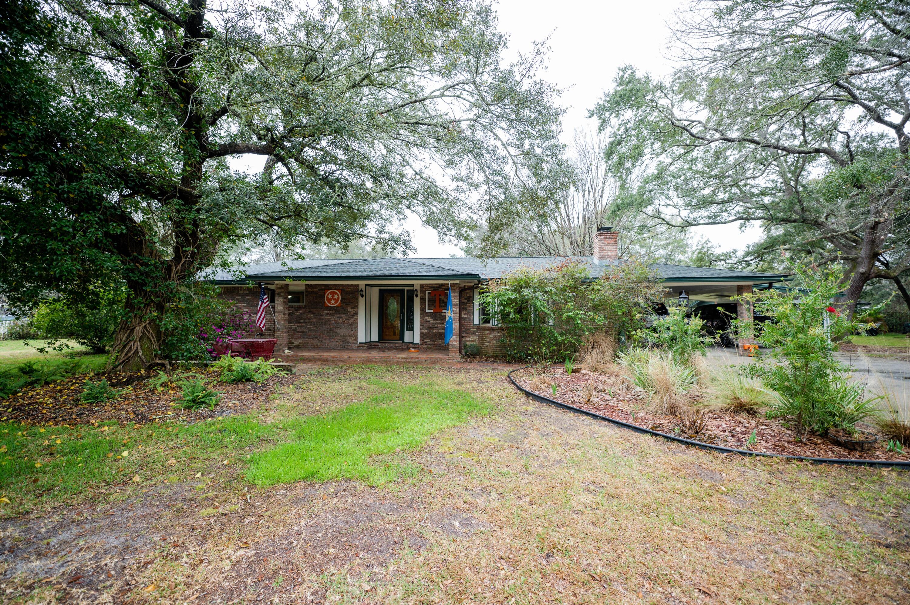 a view of an house with backyard space and garden