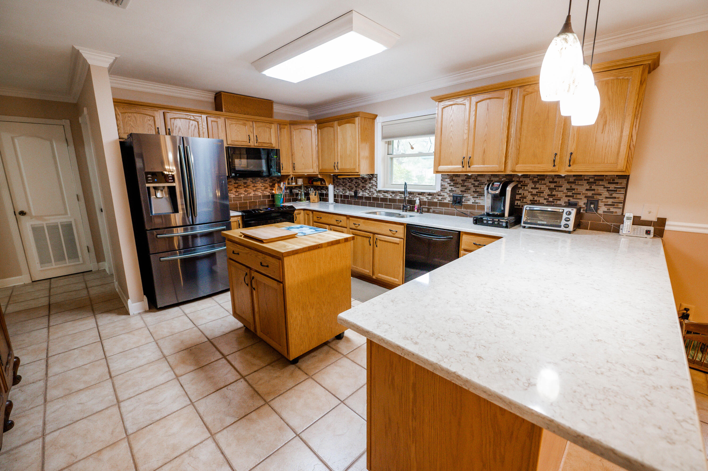 218 Howard Street Niceville, FL 32578 - Photo 12 of 36 a kitchen with stainless steel appliances granite countertop a refrigerator a stove and a sink
