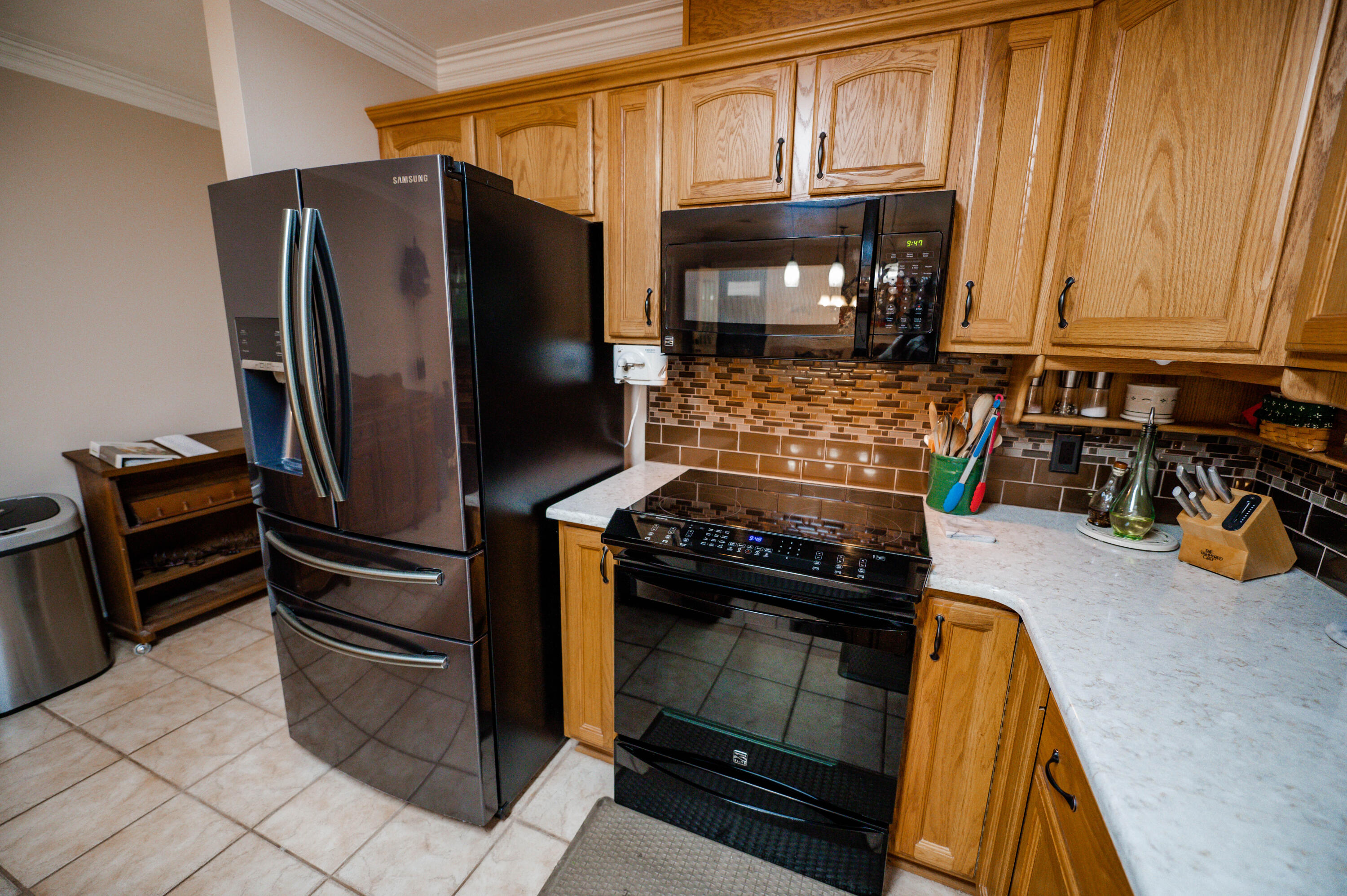 218 Howard Street Niceville, FL 32578 - Photo 13 of 36 a kitchen with stainless steel appliances granite countertop a refrigerator and a stove top oven