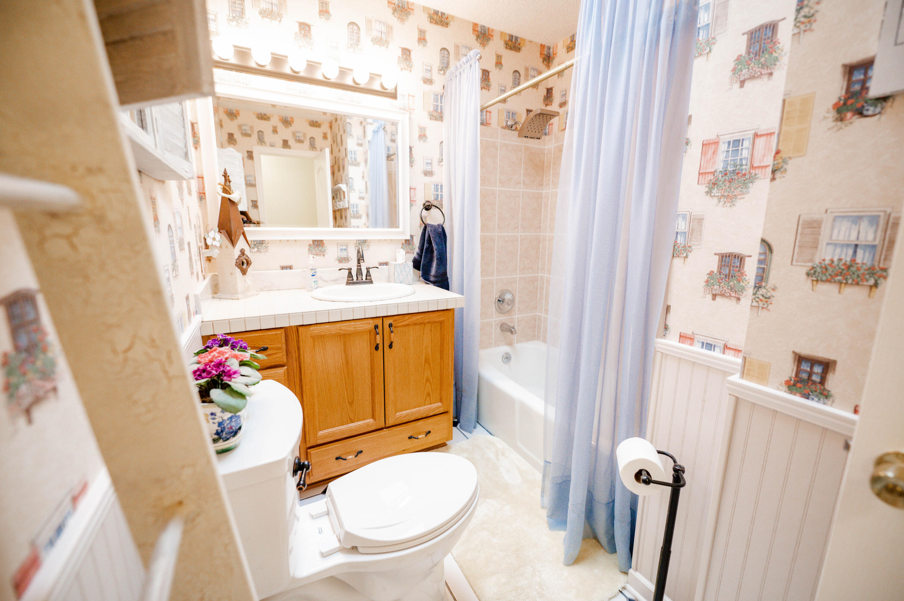 218 Howard Street Niceville, FL 32578 - Photo 16 of 36 a bathroom with a sink toilet mirror vanity and window