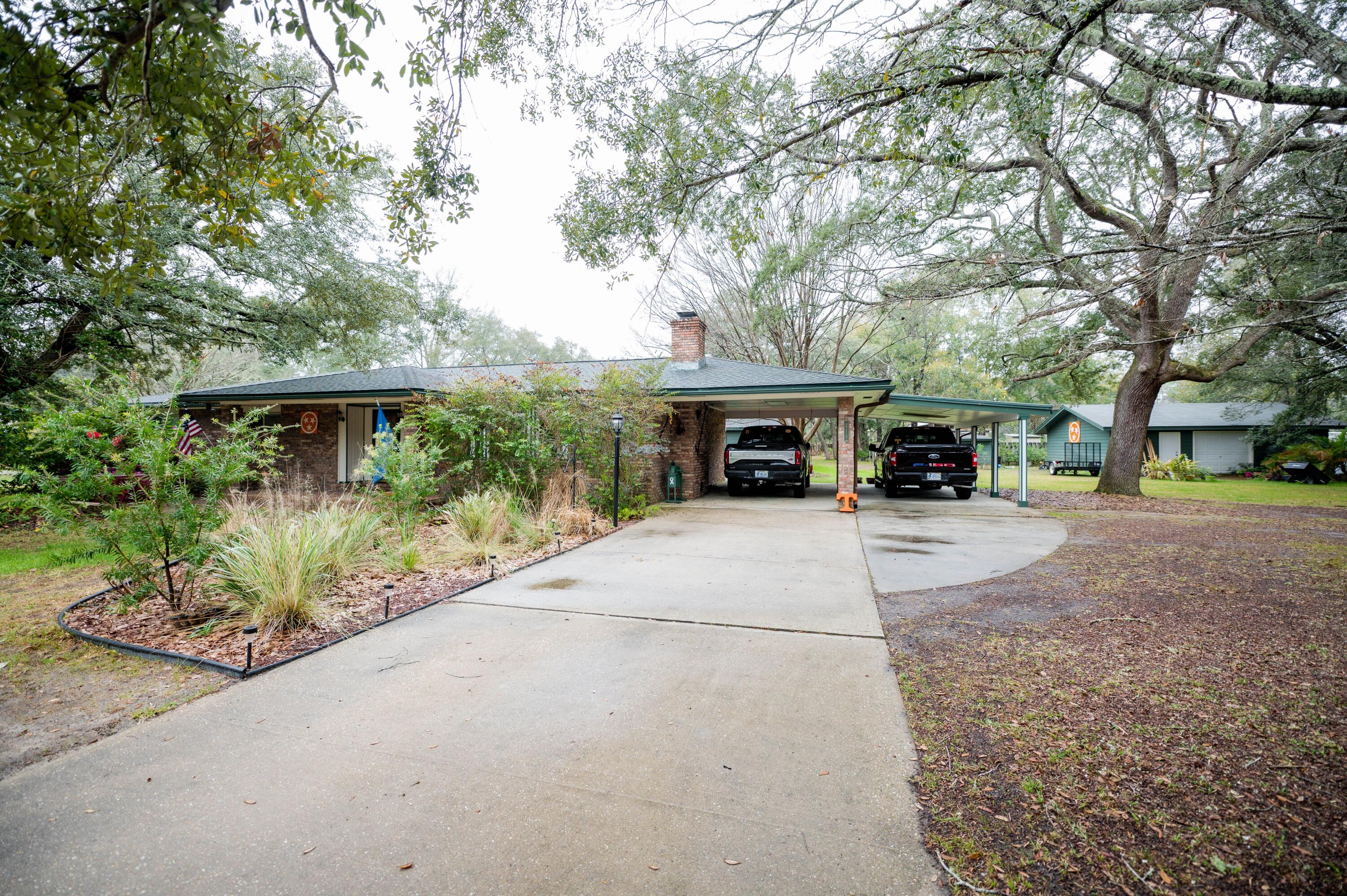 218 Howard Street Niceville, FL 32578 - Photo 2 of 36 a view of house with outdoor space and garden