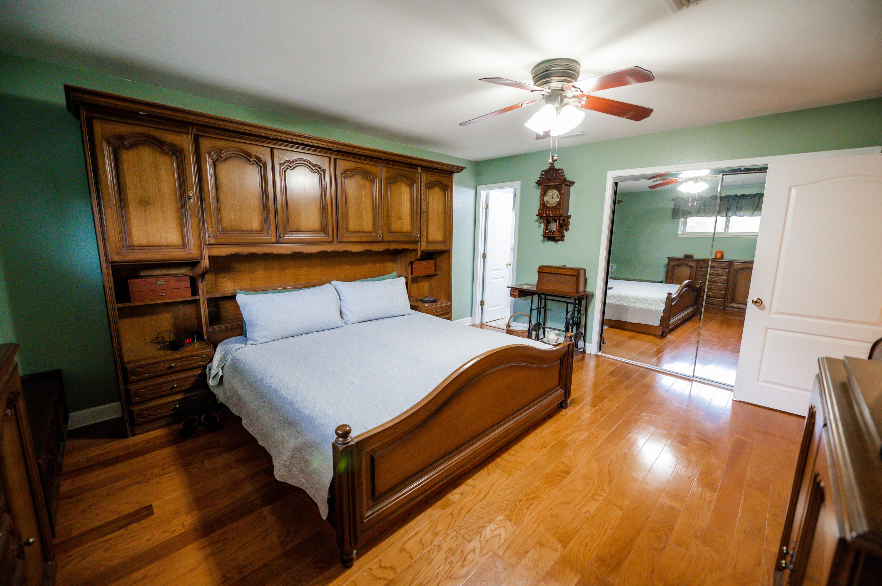 218 Howard Street Niceville, FL 32578 - Photo 21 of 36 a bed room with a bed and a chandelier