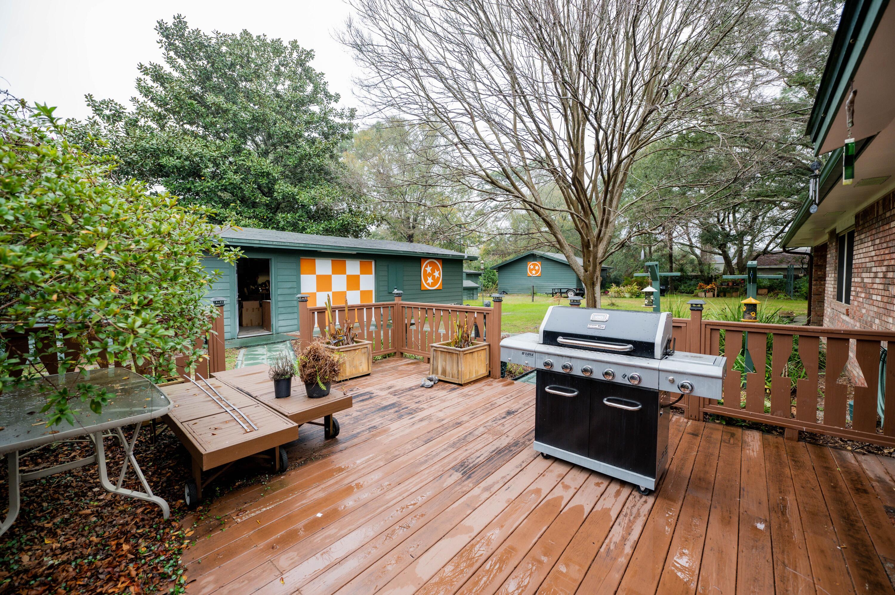 218 Howard Street Niceville, FL 32578 - Photo 29 of 36 a view of a patio with table and chairs wooden floor and fence