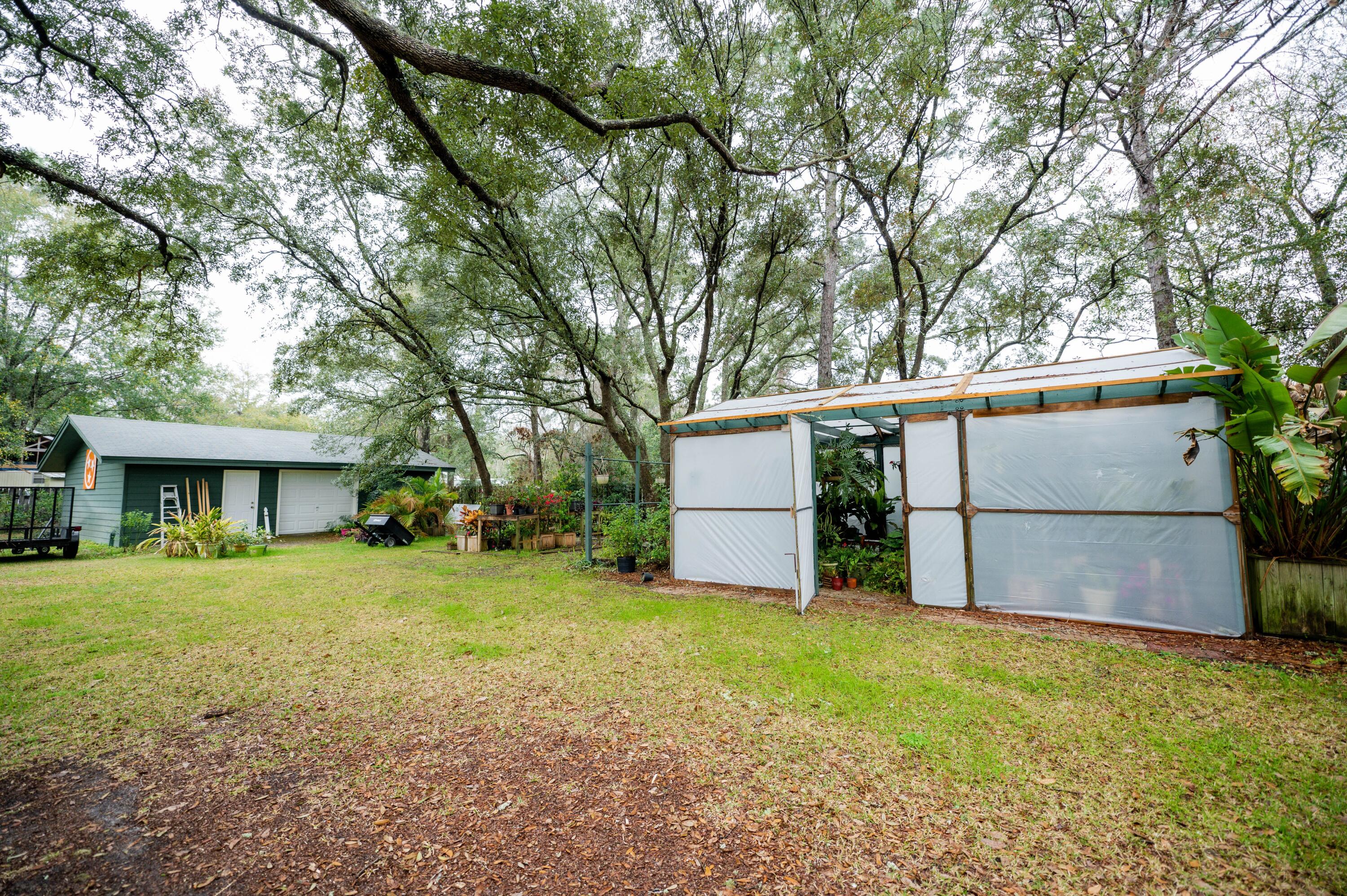 218 Howard Street Niceville, FL 32578 - Photo 33 of 36 a view of a backyard with large trees