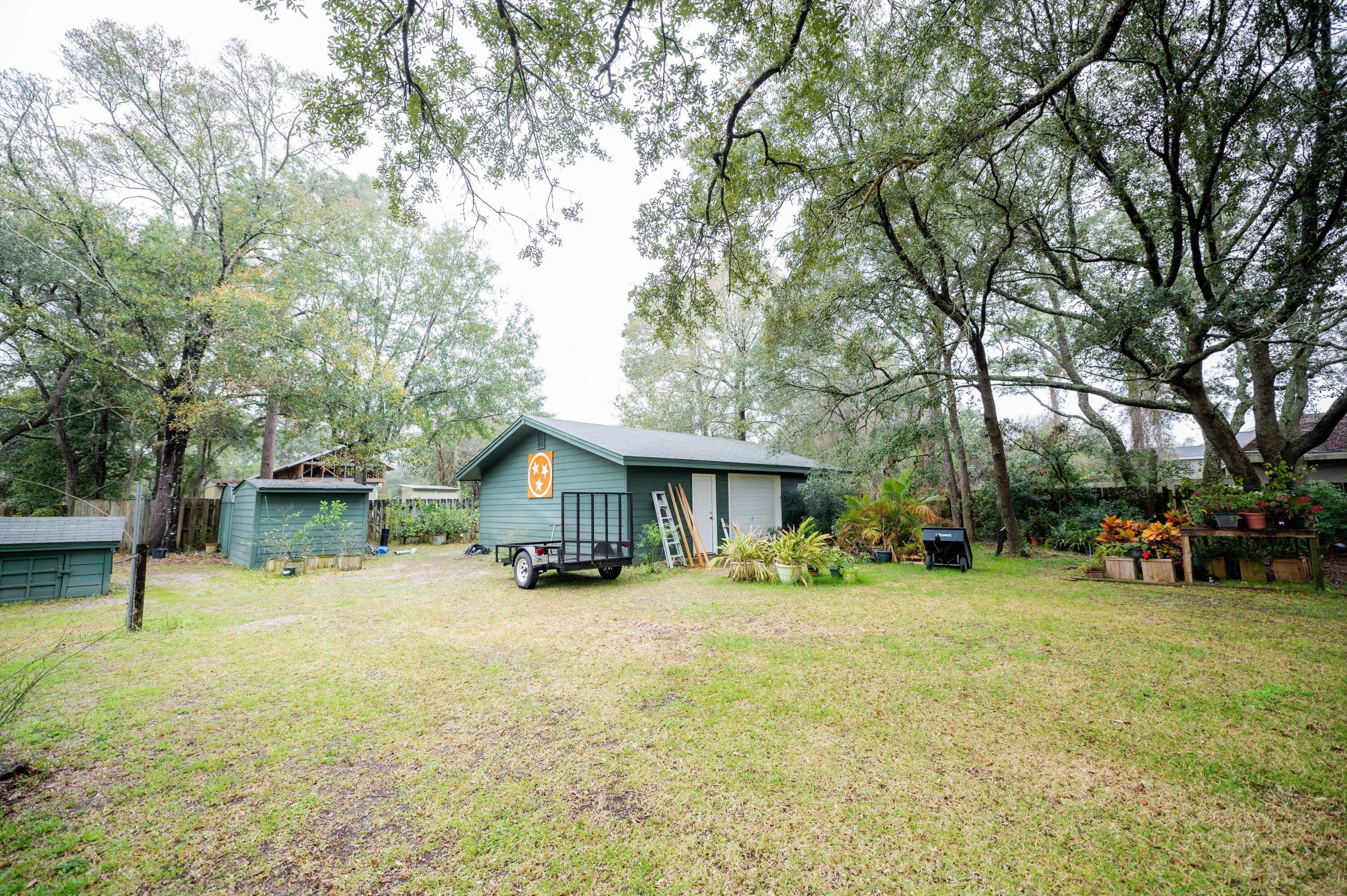 218 Howard Street Niceville, FL 32578 - Photo 34 of 36 a view of a house with a yard covered with trees