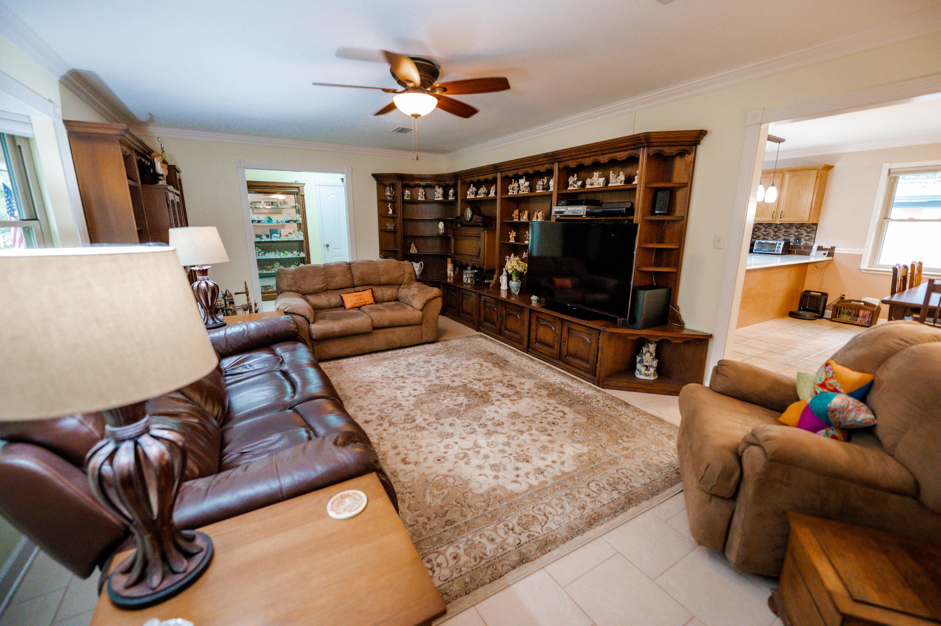 218 Howard Street Niceville, FL 32578 - Photo 5 of 36 a living room with furniture a flat screen tv and a large window