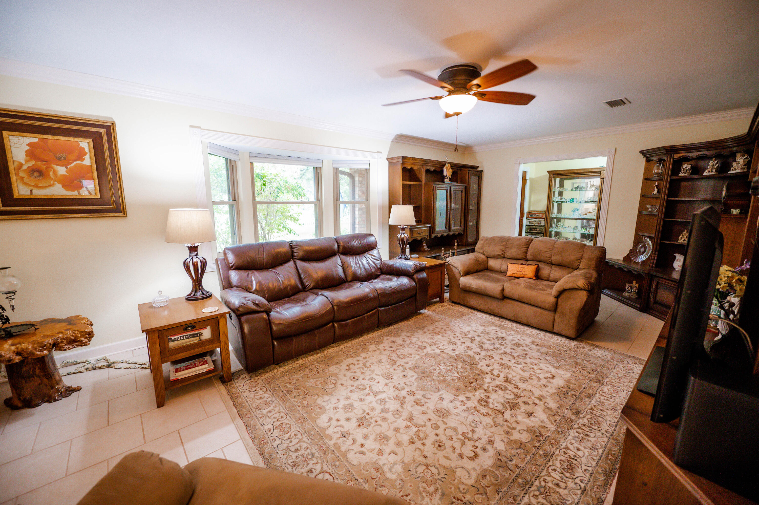 218 Howard Street Niceville, FL 32578 - Photo 6 of 36 a living room with furniture ceiling fan and a window