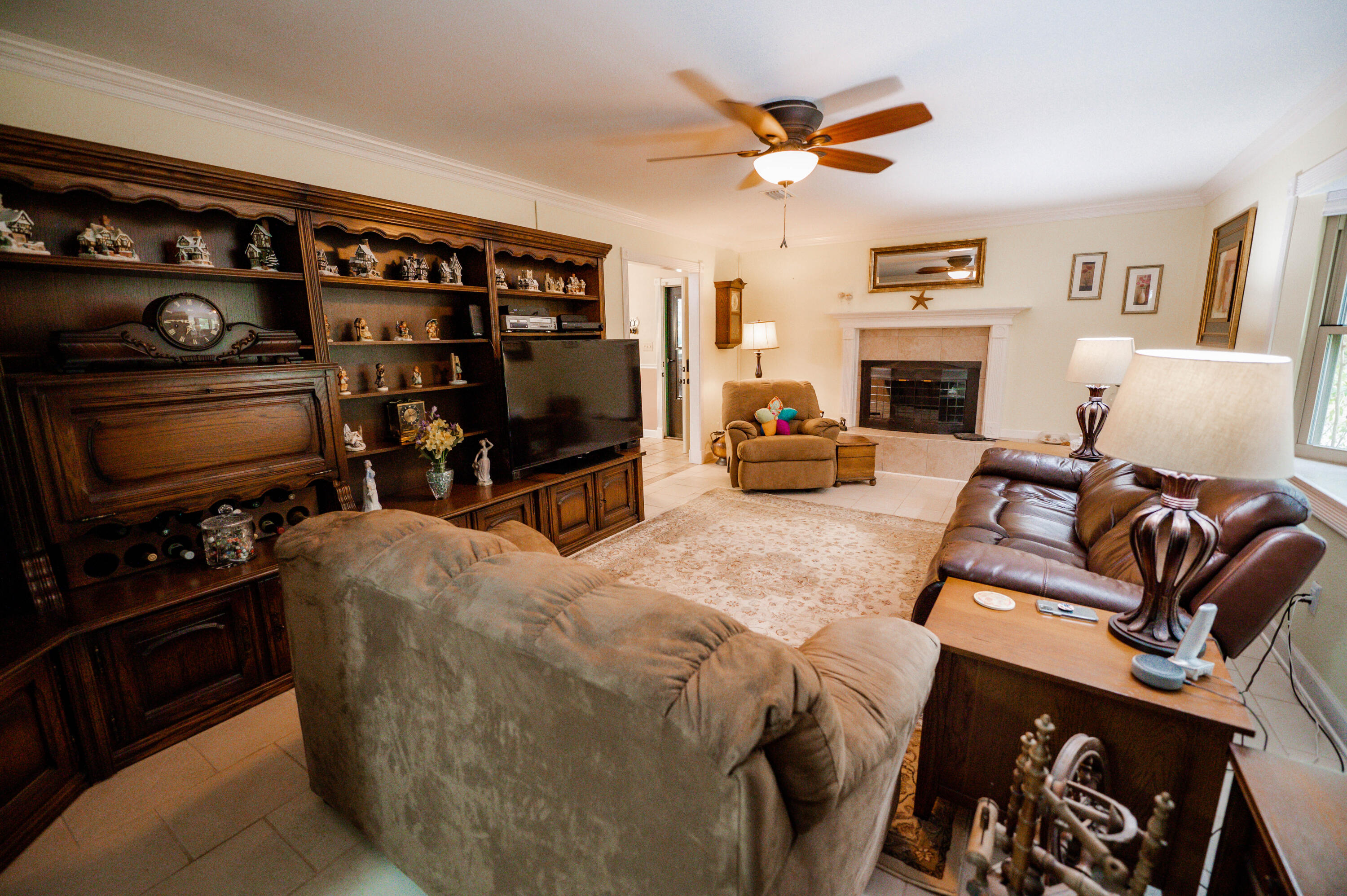 218 Howard Street Niceville, FL 32578 - Photo 7 of 36 a living room with furniture a flat screen tv and a fireplace