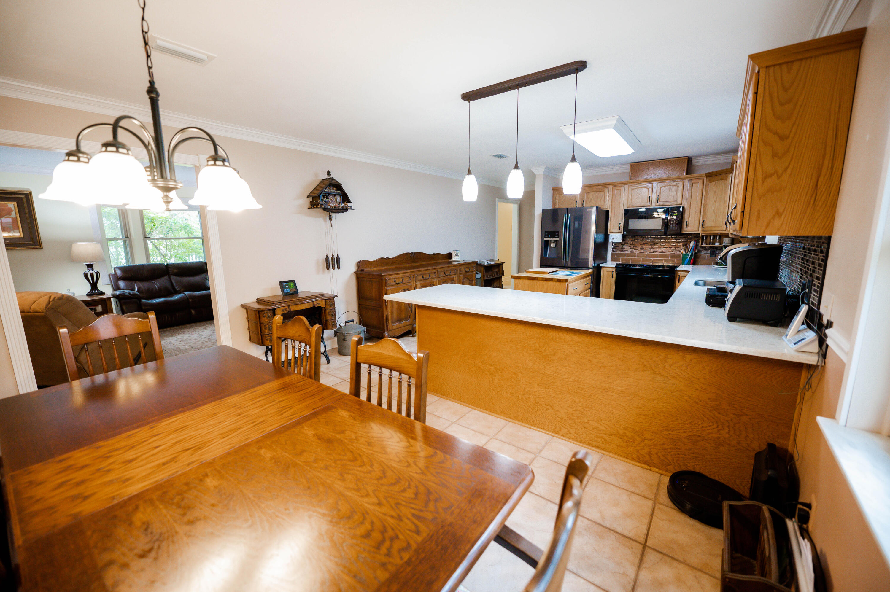 218 Howard Street Niceville, FL 32578 - Photo 9 of 36 a view of a dining room with furniture and a chandelier
