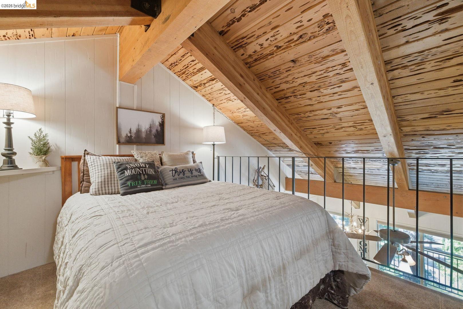33840 Upper Leland Road, Unit 25A Pinecrest, CA 95364 - Photo 16 of 41 a bedroom with a large bed and a chandelier