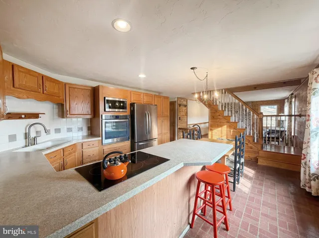 a kitchen with stainless steel appliances granite countertop a sink and cabinets