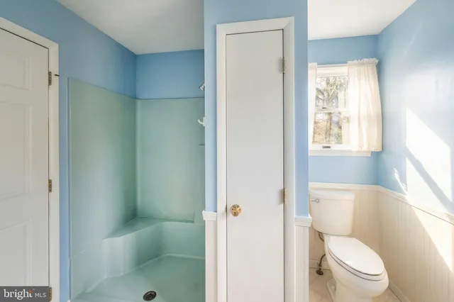 a dining room with furniture and a window