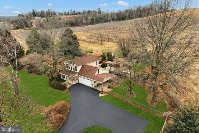 a view of a lake with couches and wooden fence