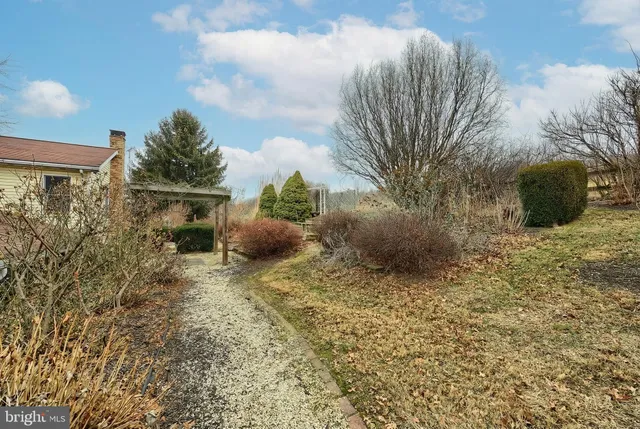 a bedroom with wooden floor and windows