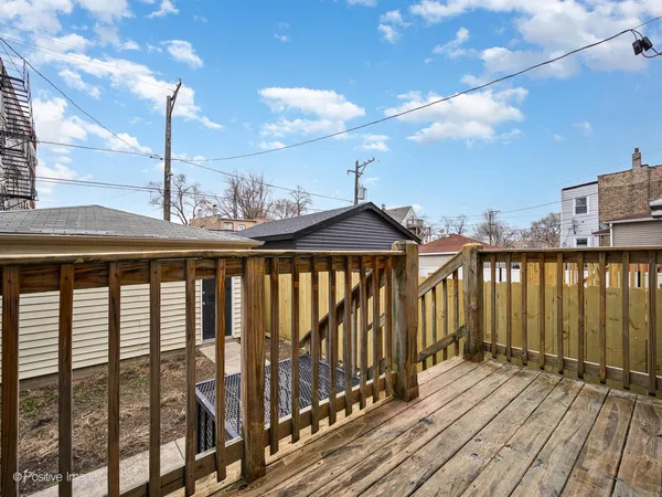 a view of balcony with wooden floor and fence