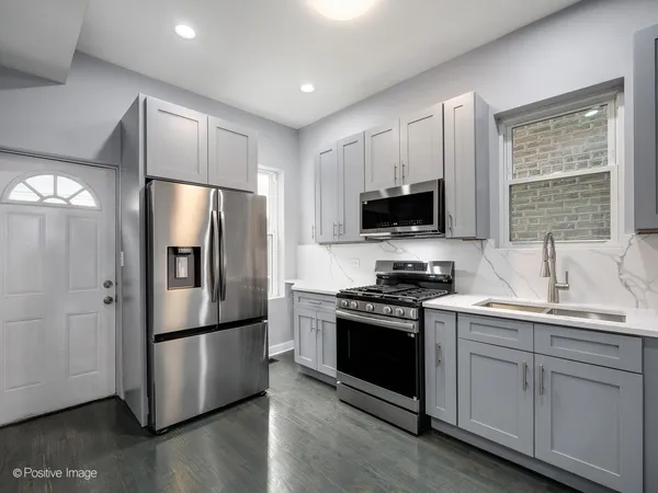 a kitchen with stainless steel appliances a refrigerator stove and sink