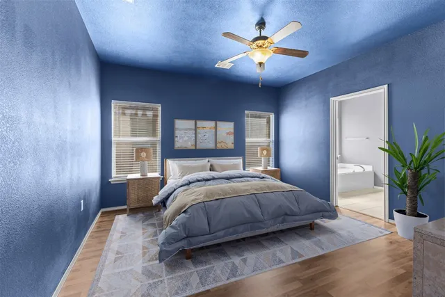 a bedroom with a large bed and a chandelier