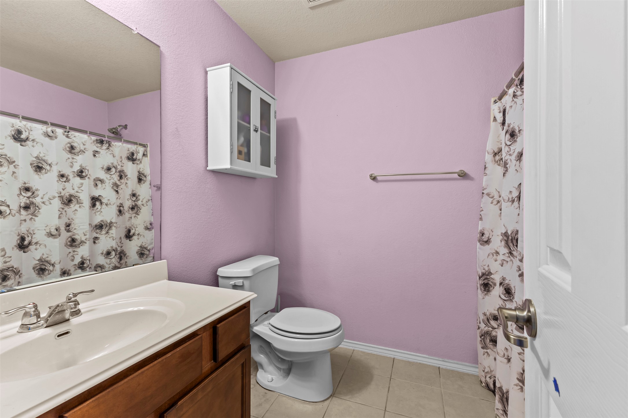 5709 Zachary Scott Street Austin, TX 78747 - Photo 20 of 29 a bathroom with a sink a toilet a shower and a mirror