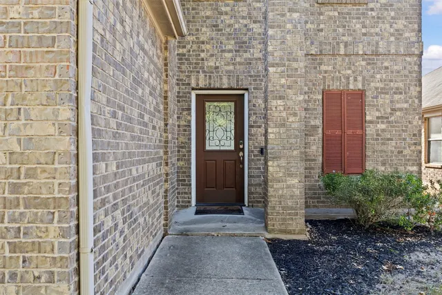 a front view of a house with a brick wall