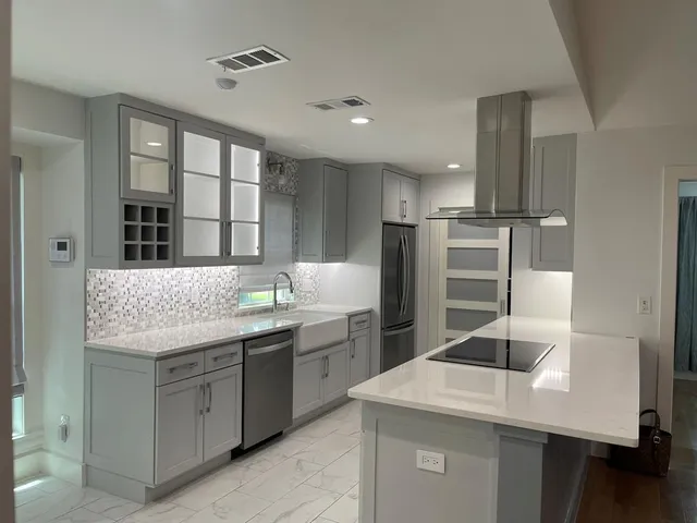 a kitchen with center island and stainless steel appliances