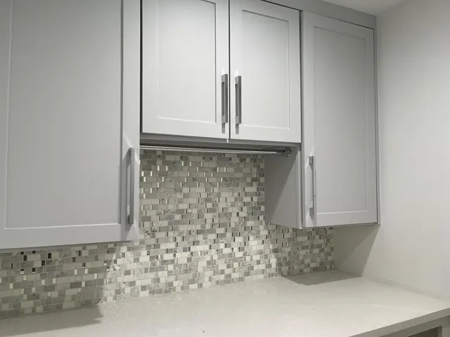 a bathroom with a granite countertop window and a shower